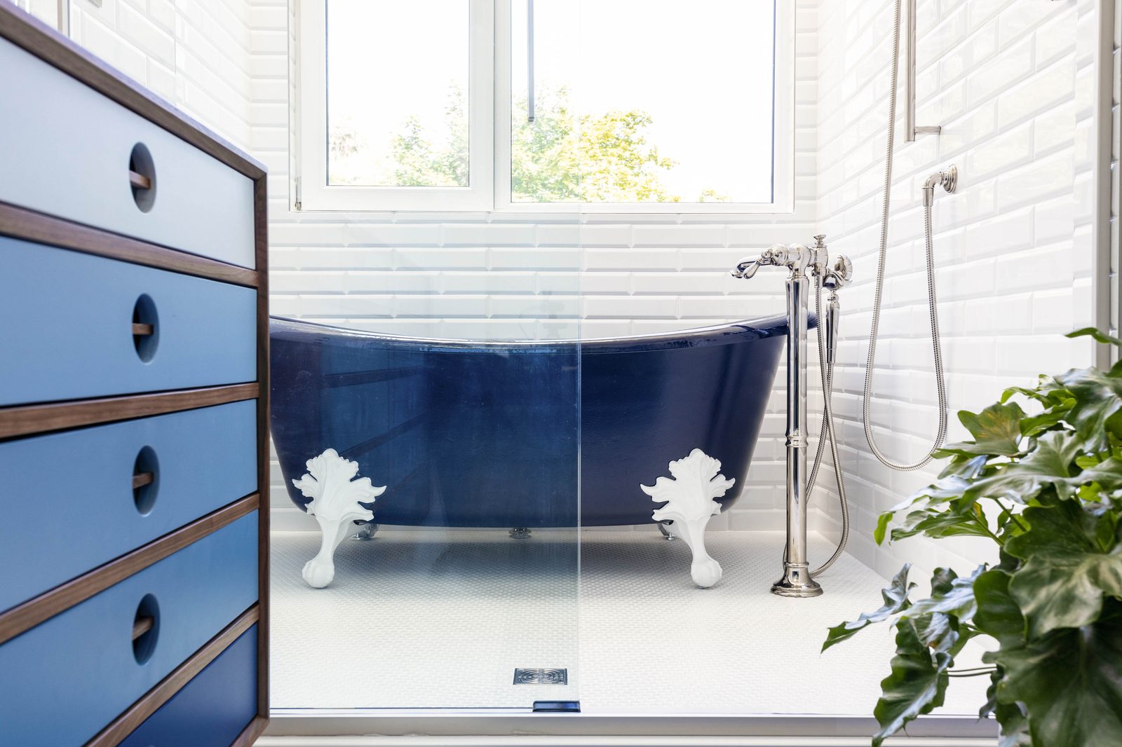 Editorial interior photograph of a main bathroom with a freestanding tub viewed from the vanity — showing the kind of clean, transparent quality designers expect when hiring an editorial-grade interior photographer.