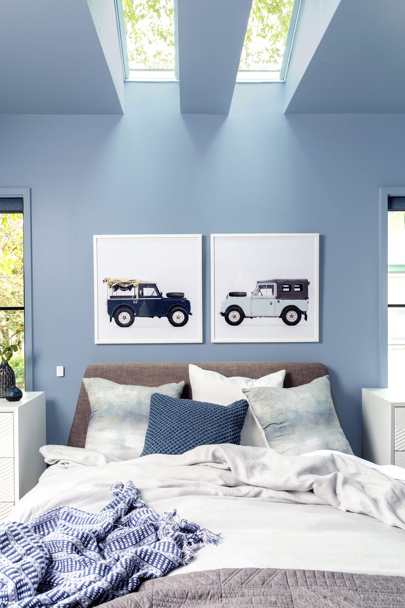Vertical interior photograph of a master bedroom with skylights and soft daylight — editorial work showing the kind of styled bedroom imagery a designer typically licenses with a contractor or builder under a cost-share agreement.