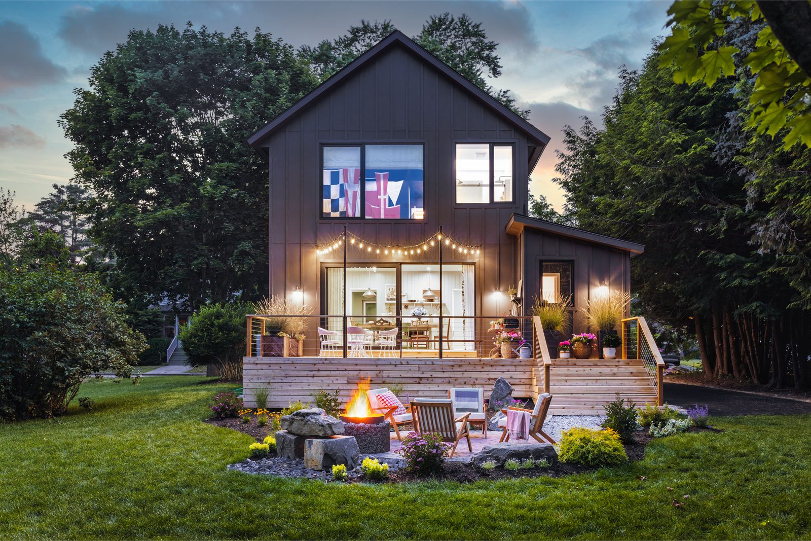 Evening exterior photograph of a residential backyard with landscape lighting on — taken on a Southern travel-day interior photography shoot outside Atlanta.