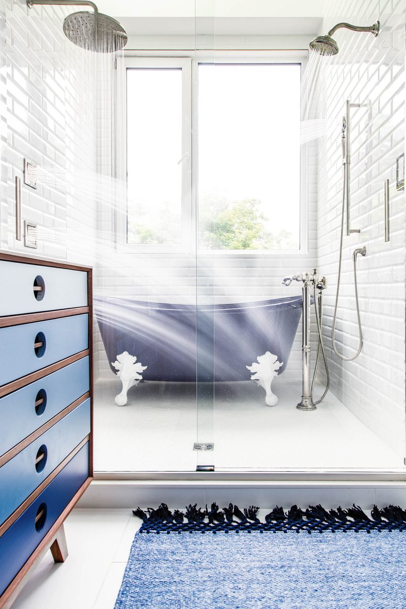 Vertical interior photograph of a main-bathroom wet room — the orientation editors need for shelter-magazine cover and lead-feature placements.