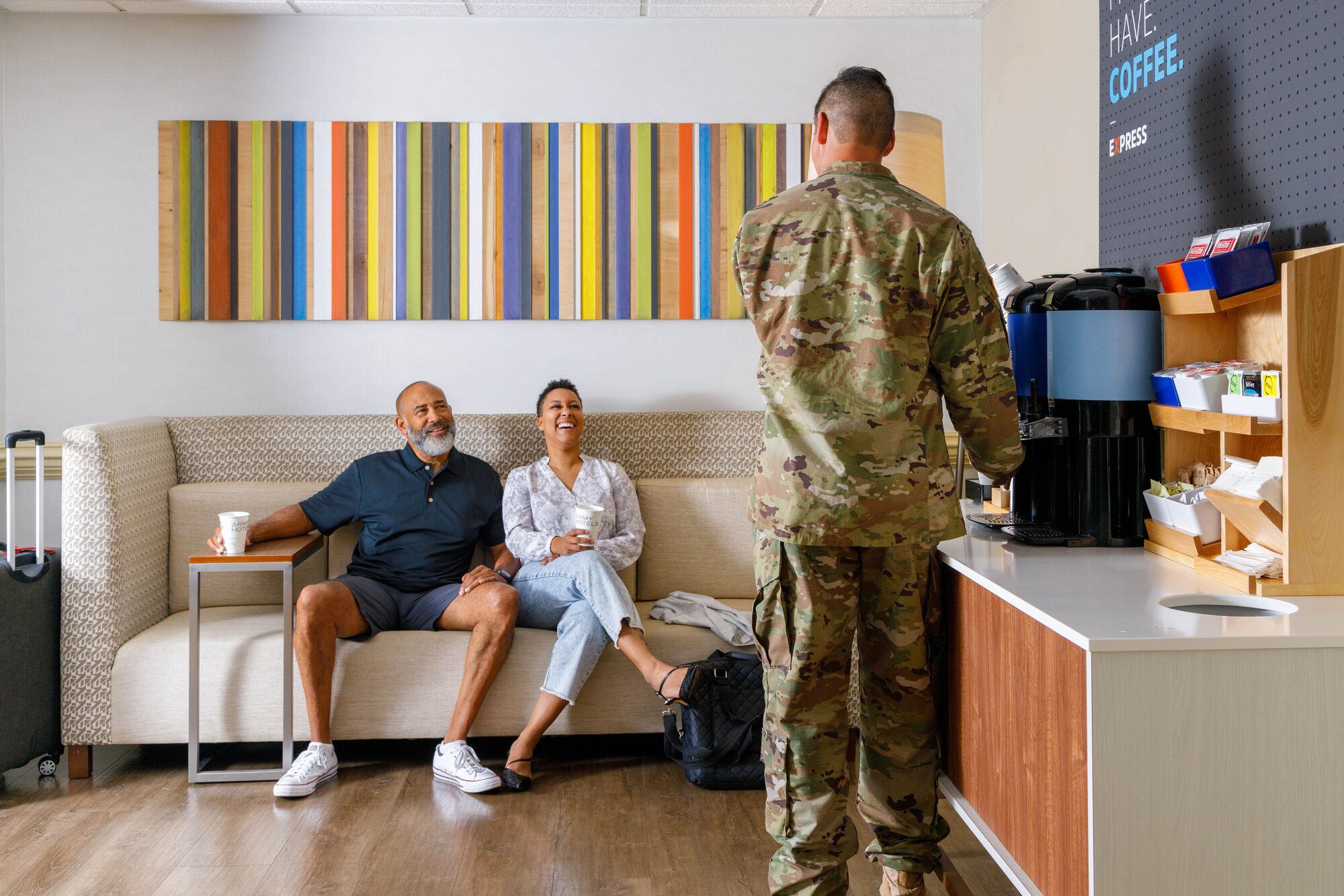 Hotel lobby lounge with guests at coffee station — lifestyle photography