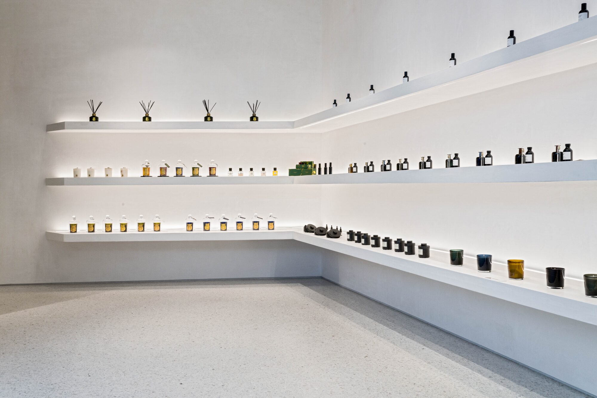 Luxury retail fragrance display with minimalist shelving
