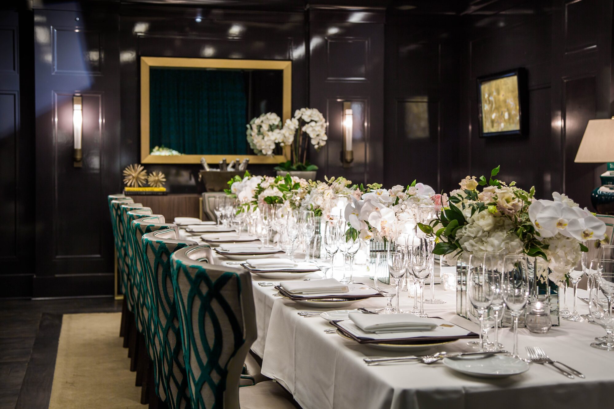 Private dining room with formal table setting and floral centerpieces