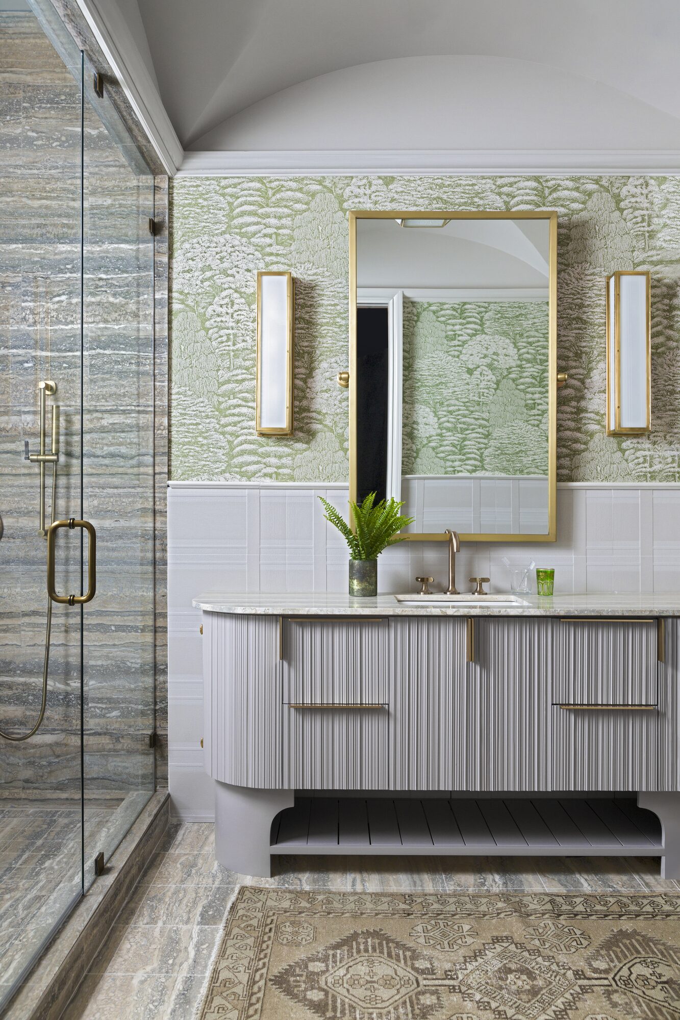 Custom bathroom vanity with fluted cabinetry and brass hardware