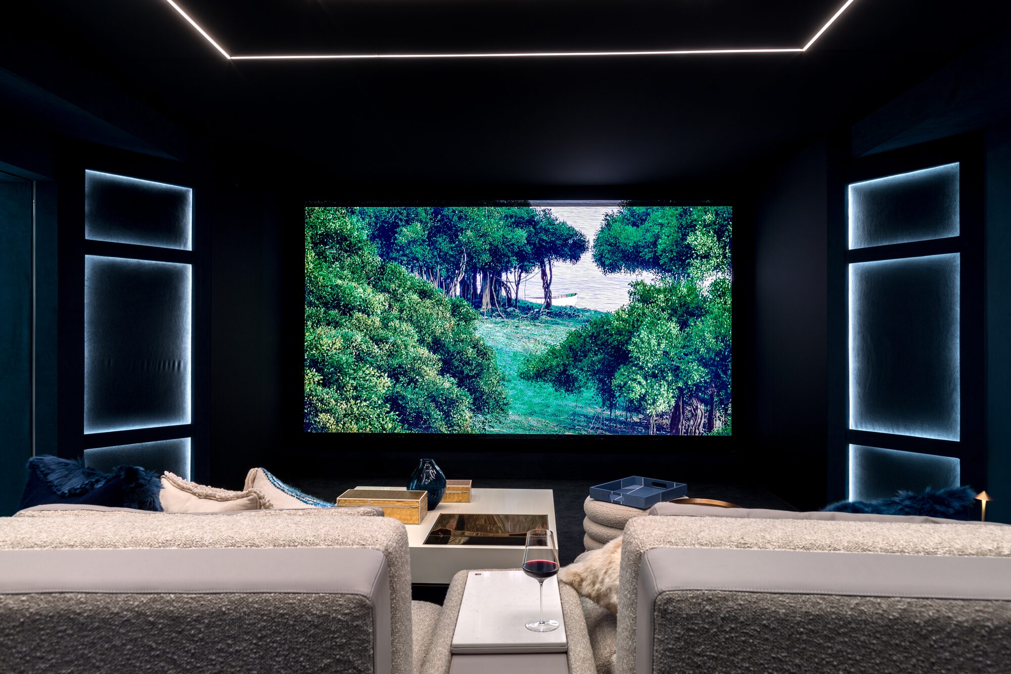 Custom home theater with ambient lighting and plush seating