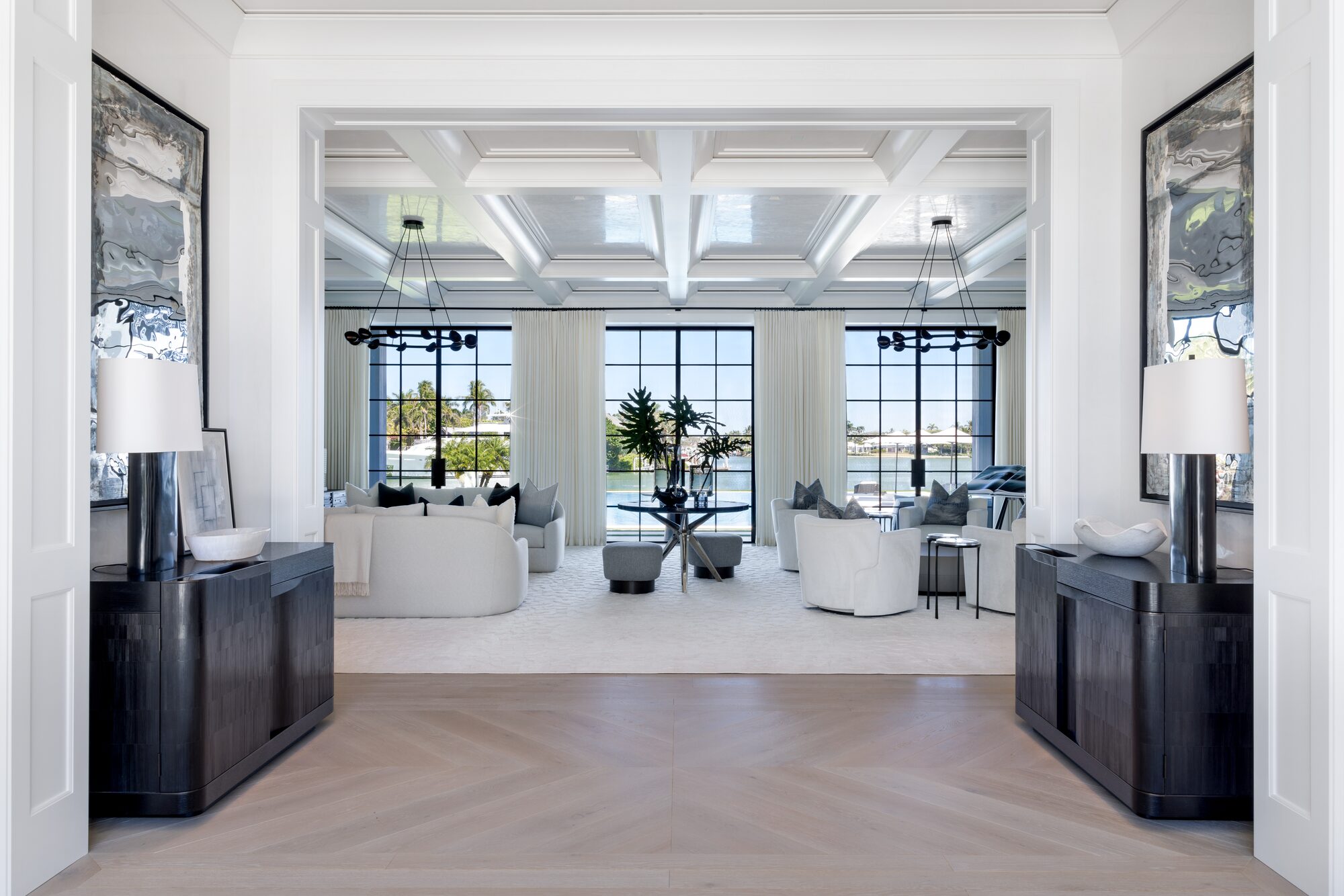 Grand living room with coffered ceiling and waterfront view