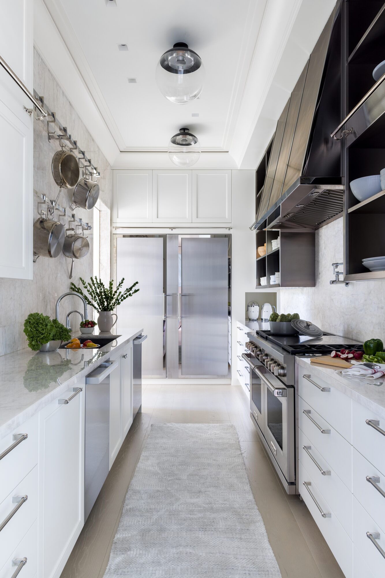 Luxury galley kitchen with professional range and white cabinetry