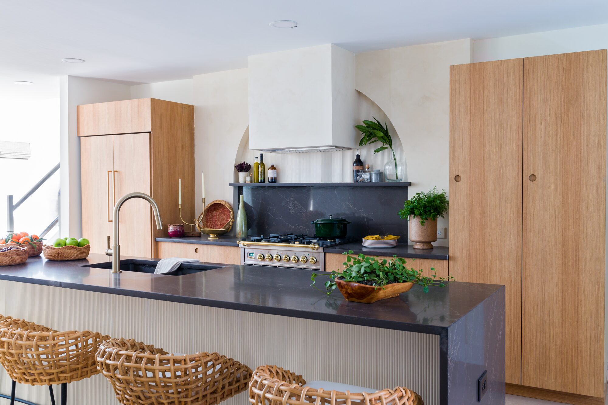 Modern kitchen with fluted island and light wood cabinetry — interior design photography