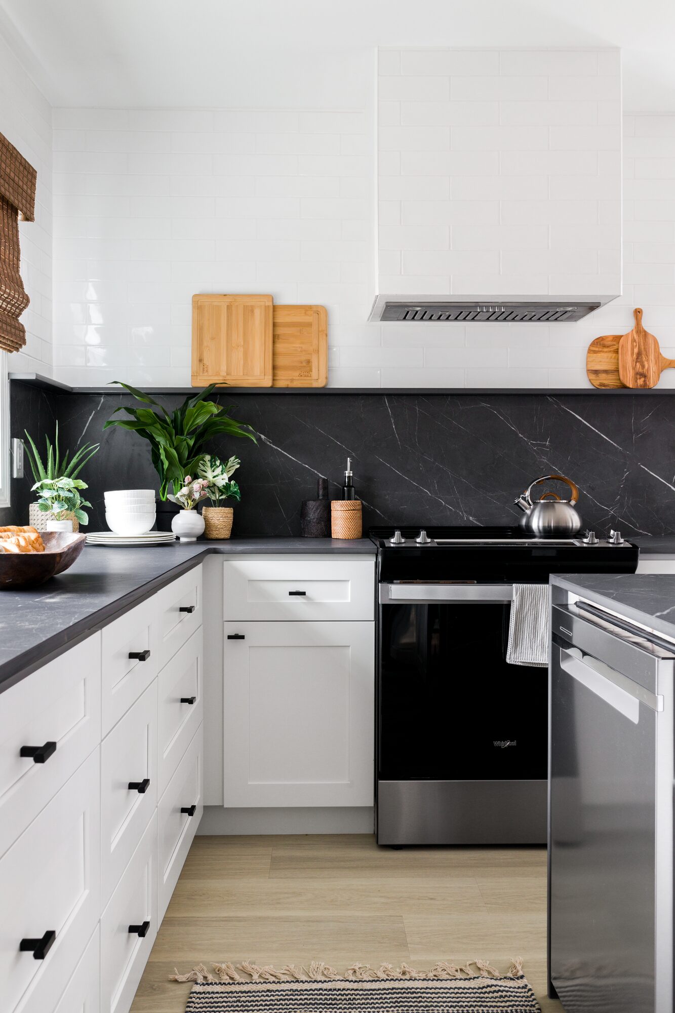 Modern white kitchen with black stone backsplash