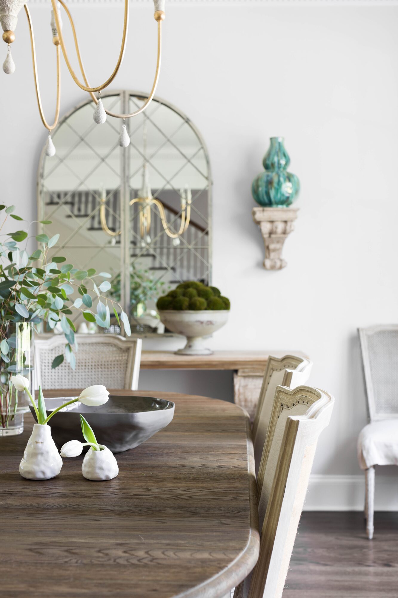 Residential dining room with arched mirror and styled tablescape